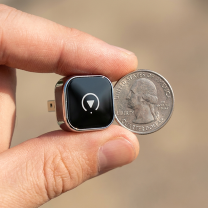 Coin-sized adapter shown next to a quarter for scale
